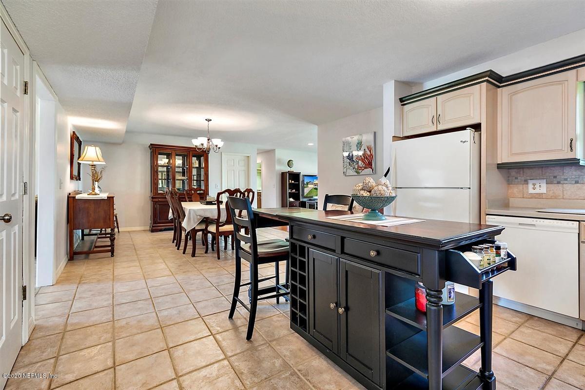 1870 Seminole Road Atlantic Beach, FL 32233 - Photo 8 of 27 a kitchen with stainless steel appliances dining table a sink and a refrigerator