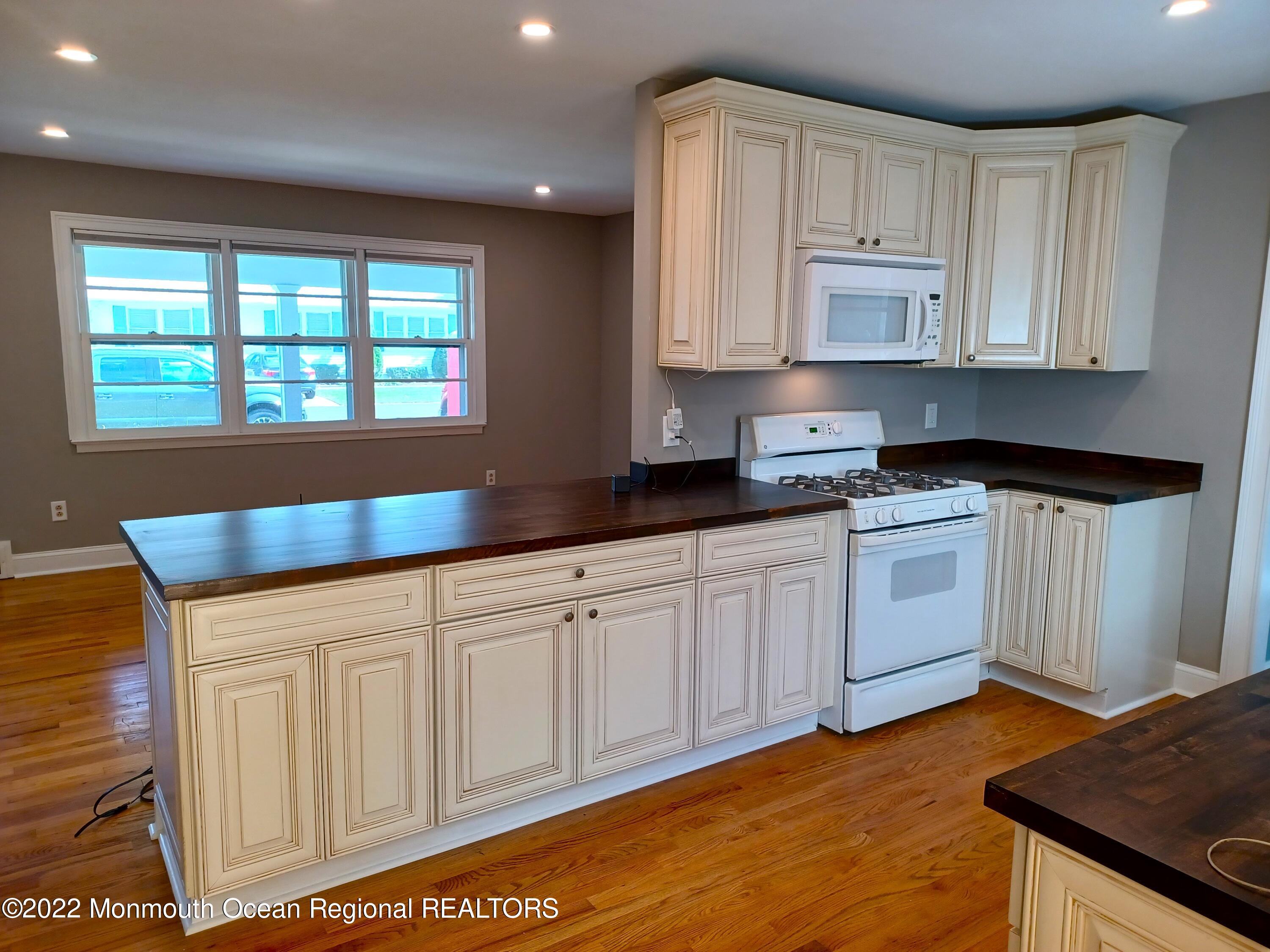 1301 Charles Street Point Pleasant, NJ 08742 - Photo 11 of 24 a kitchen with granite countertop white cabinets and white appliances