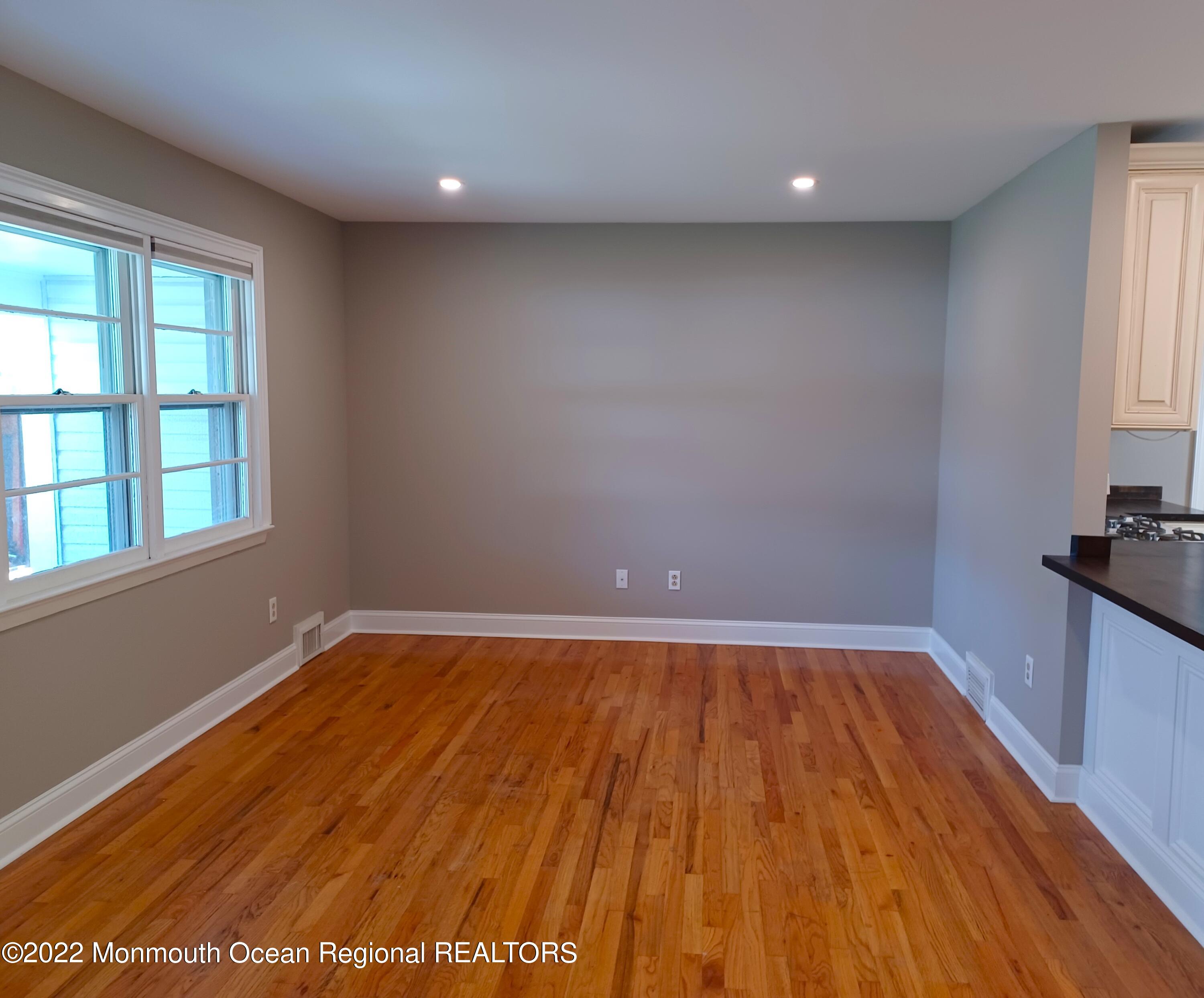 1301 Charles Street Point Pleasant, NJ 08742 - Photo 4 of 24 a view of an empty room with wooden floor and a window