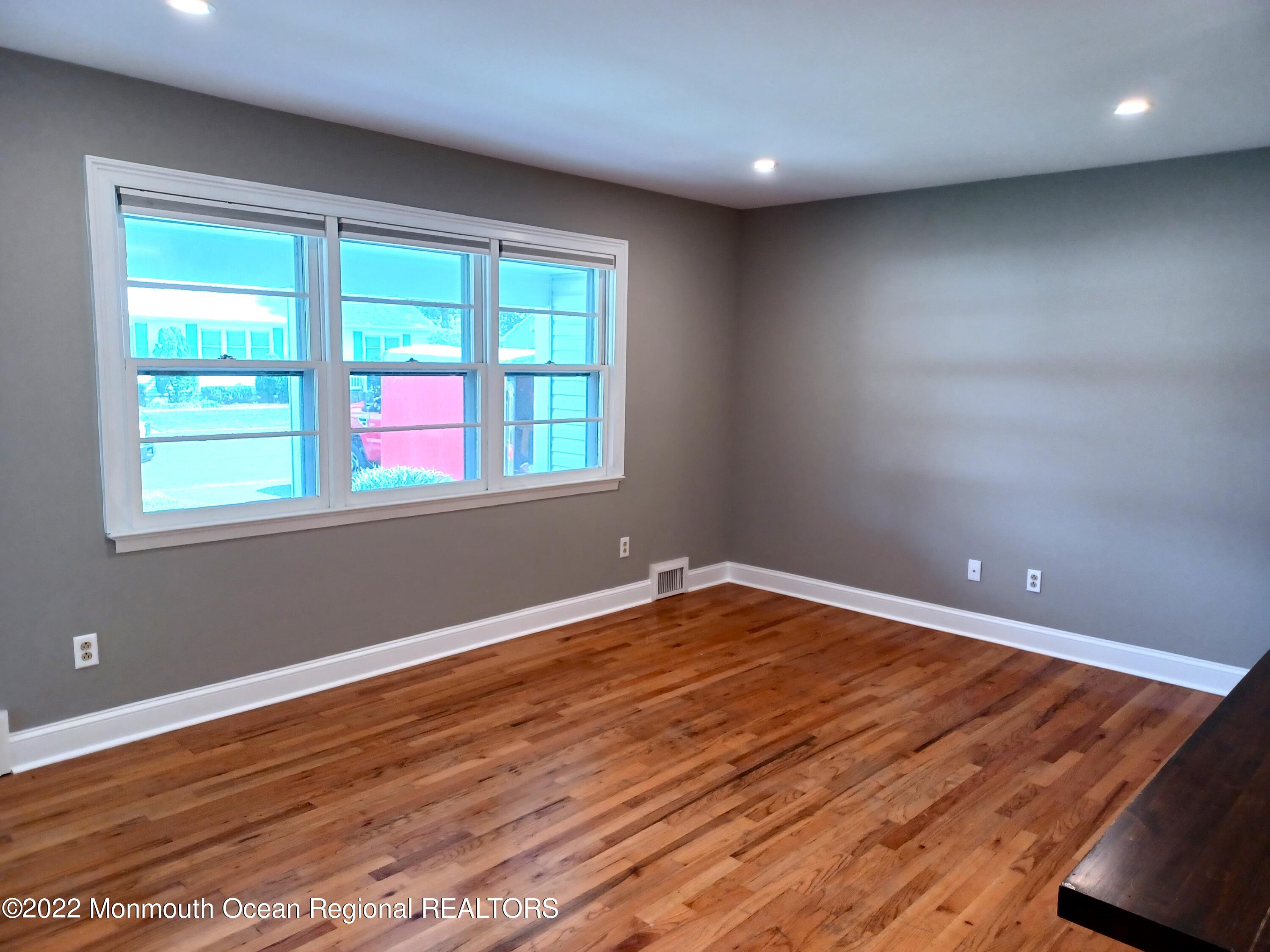 1301 Charles Street Point Pleasant, NJ 08742 - Photo 5 of 24 an empty room with wooden floor and windows