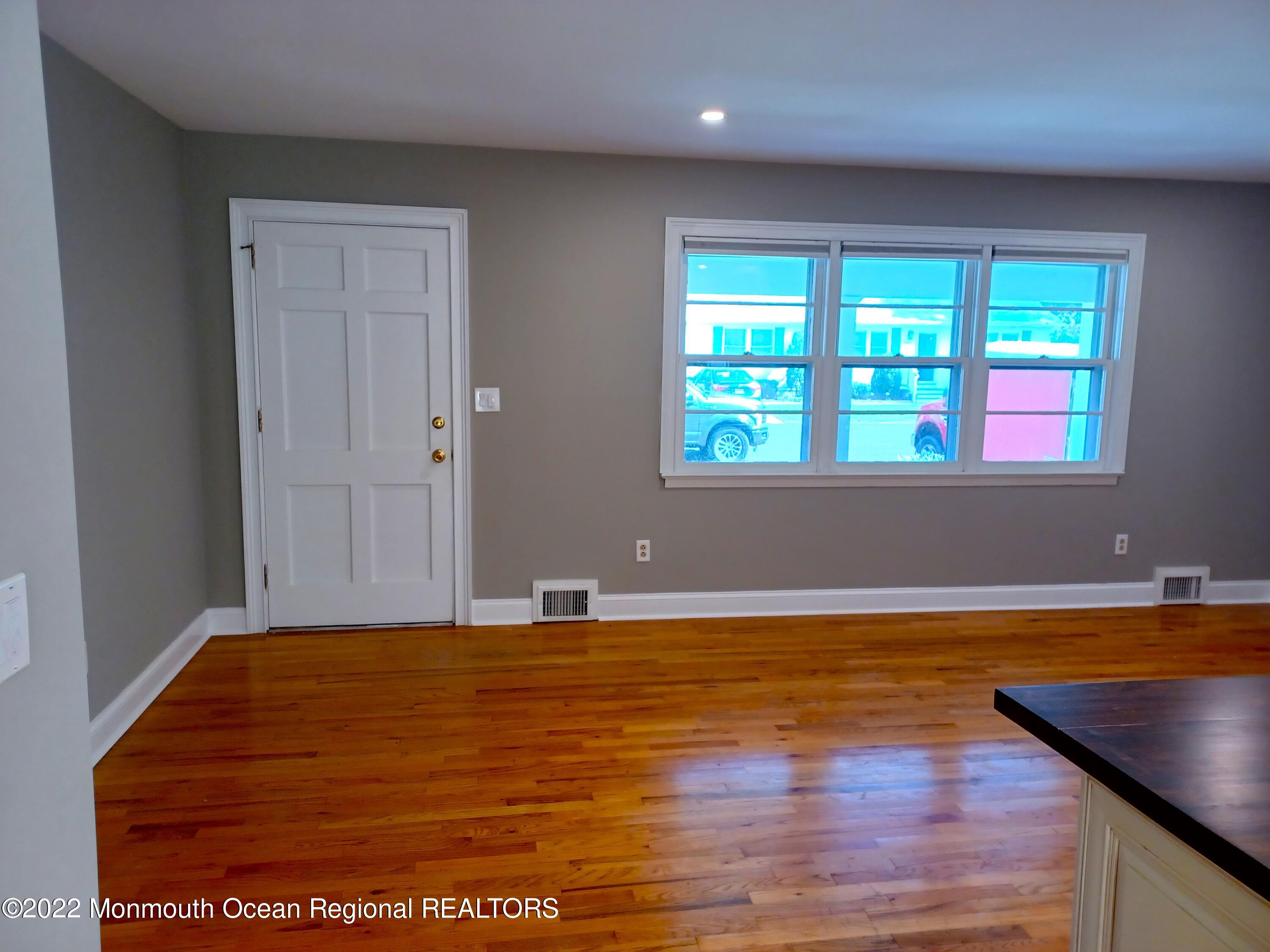 1301 Charles Street Point Pleasant, NJ 08742 - Photo 7 of 24 a view of empty room with wooden floor and fan