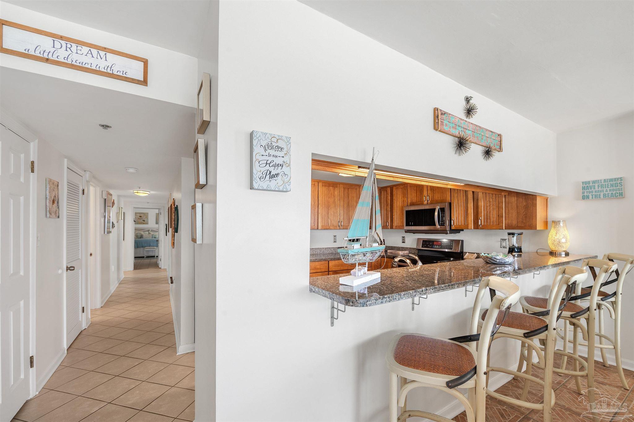 13817 Perdido Key Drive, Unit 501 Pensacola, FL 32507 - Photo 28 of 63 a kitchen view with furniture and a flat screen tv