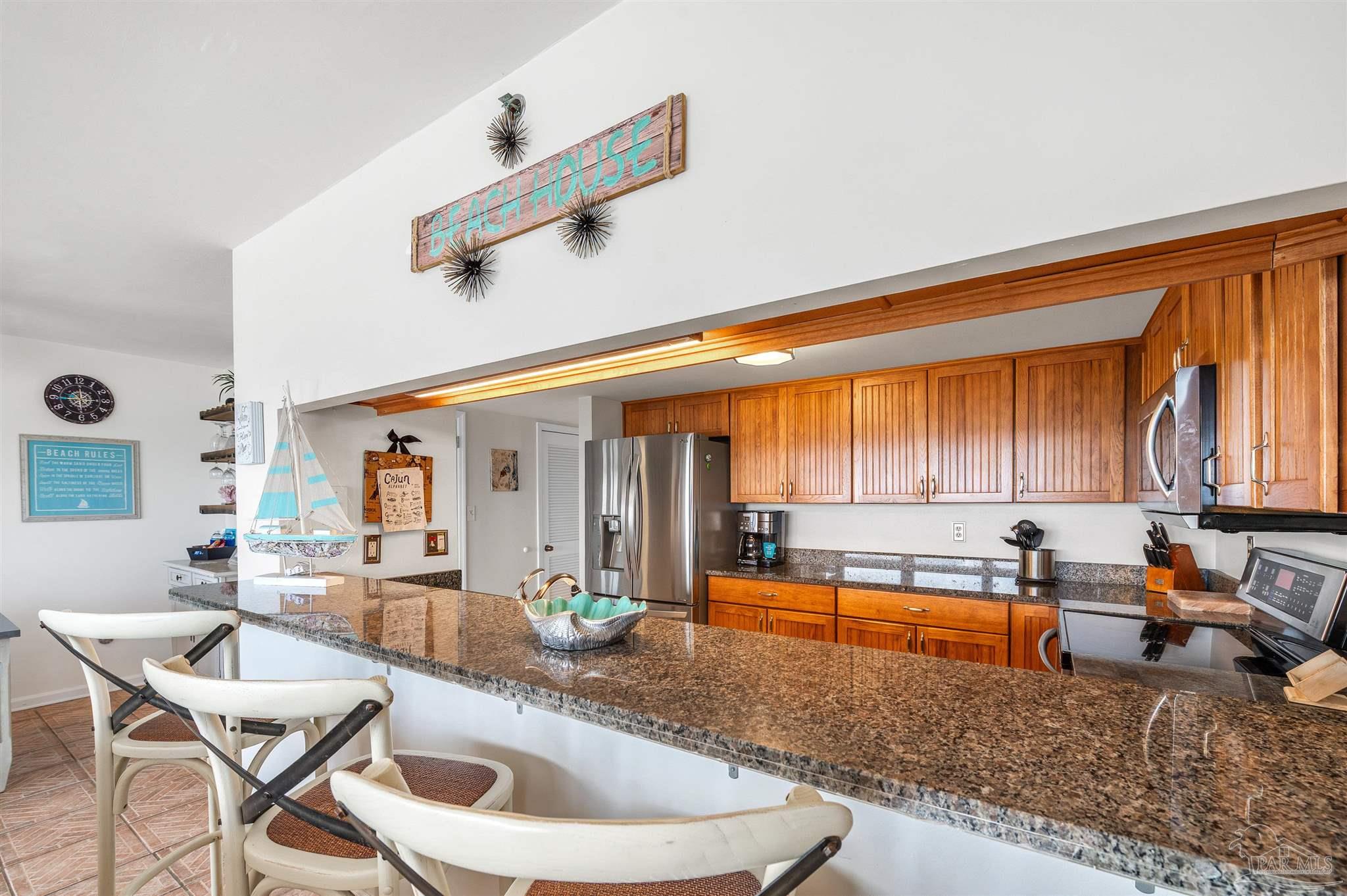 13817 Perdido Key Drive, Unit 501 Pensacola, FL 32507 - Photo 29 of 63 a kitchen with a stove a sink and cabinets