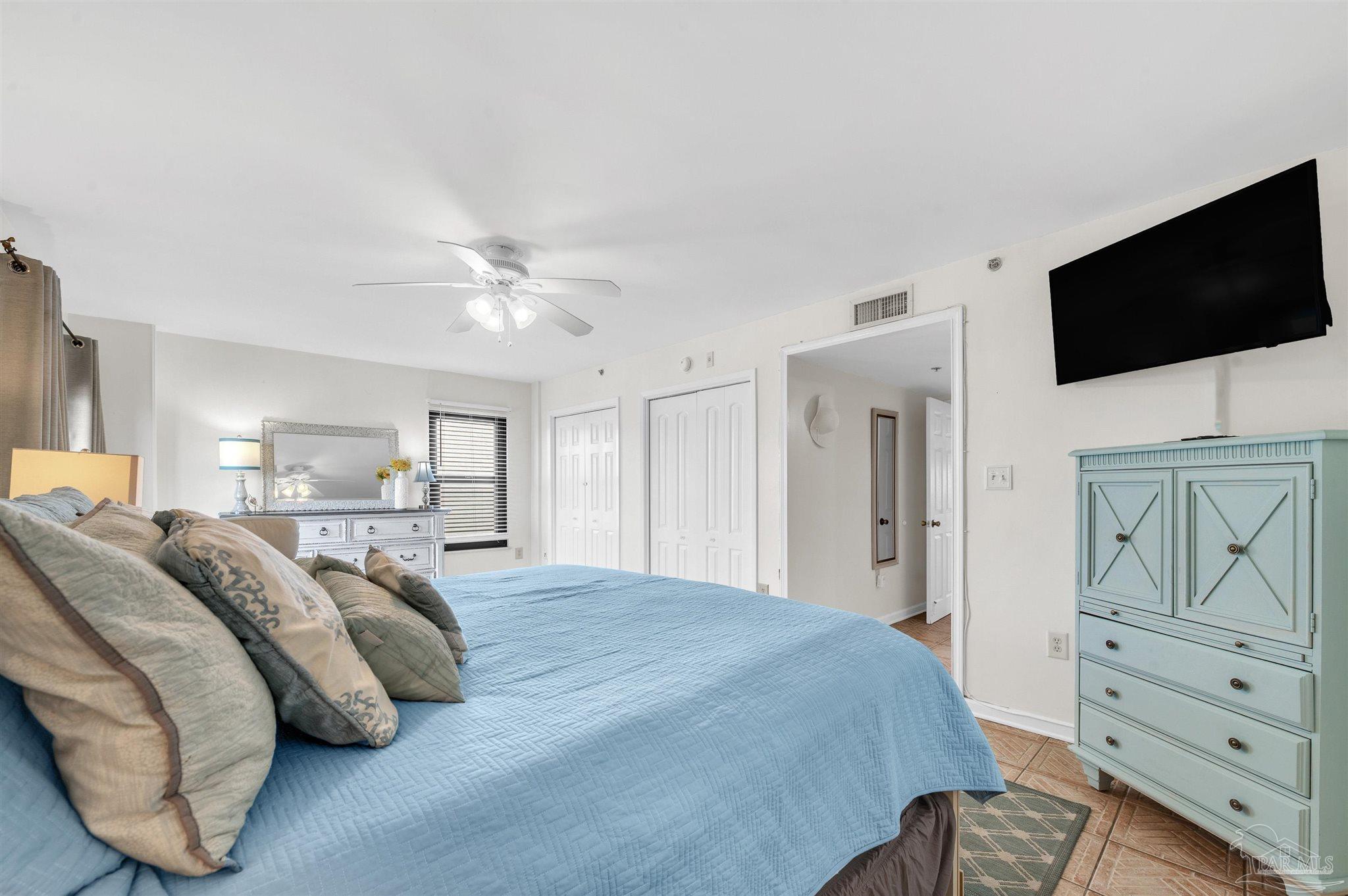 13817 Perdido Key Drive, Unit 501 Pensacola, FL 32507 - Photo 36 of 63 a spacious bedroom with a bed and a flat screen tv