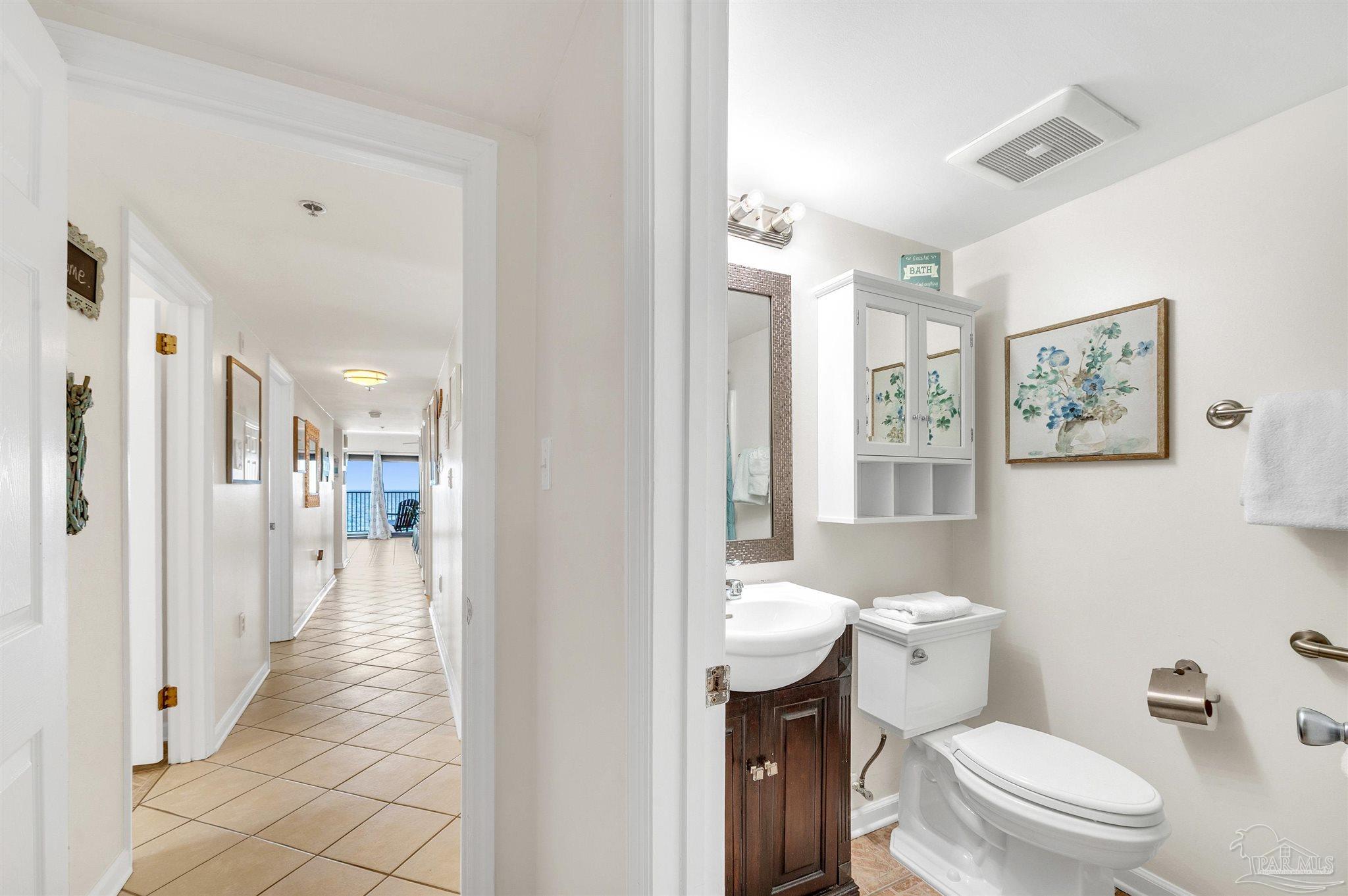 13817 Perdido Key Drive, Unit 501 Pensacola, FL 32507 - Photo 40 of 63 a bathroom with a toilet sink a shower and a mirror