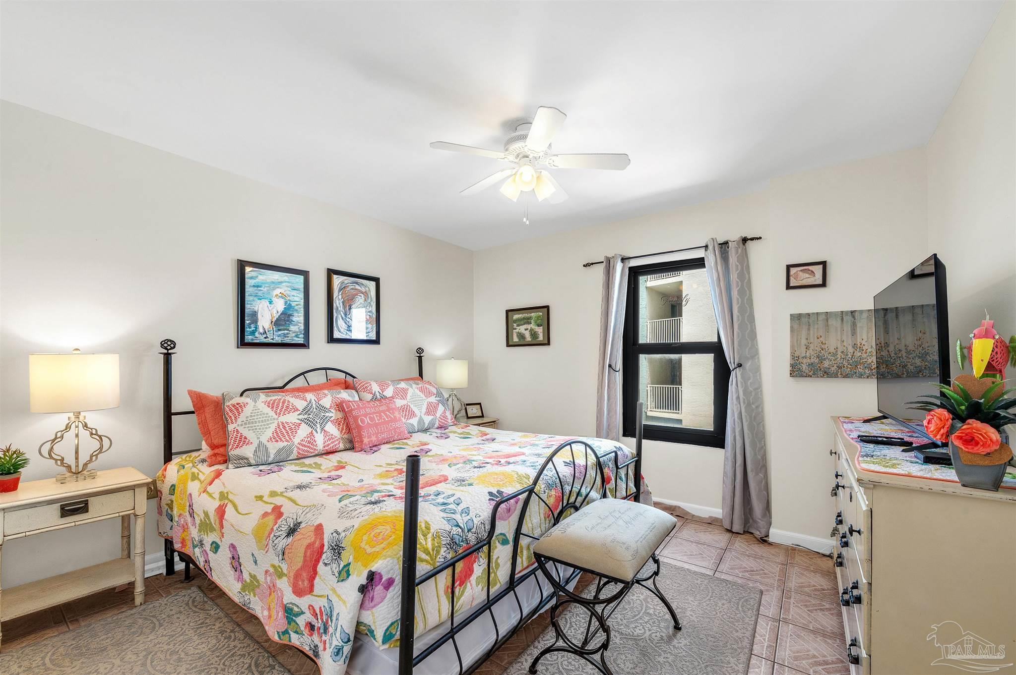 13817 Perdido Key Drive, Unit 501 Pensacola, FL 32507 - Photo 43 of 63 a bedroom with a bed and a chandelier