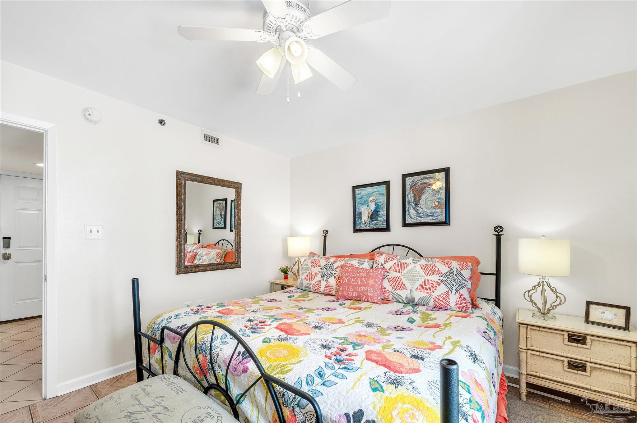 13817 Perdido Key Drive, Unit 501 Pensacola, FL 32507 - Photo 45 of 63 a bedroom with a bed and a chandelier