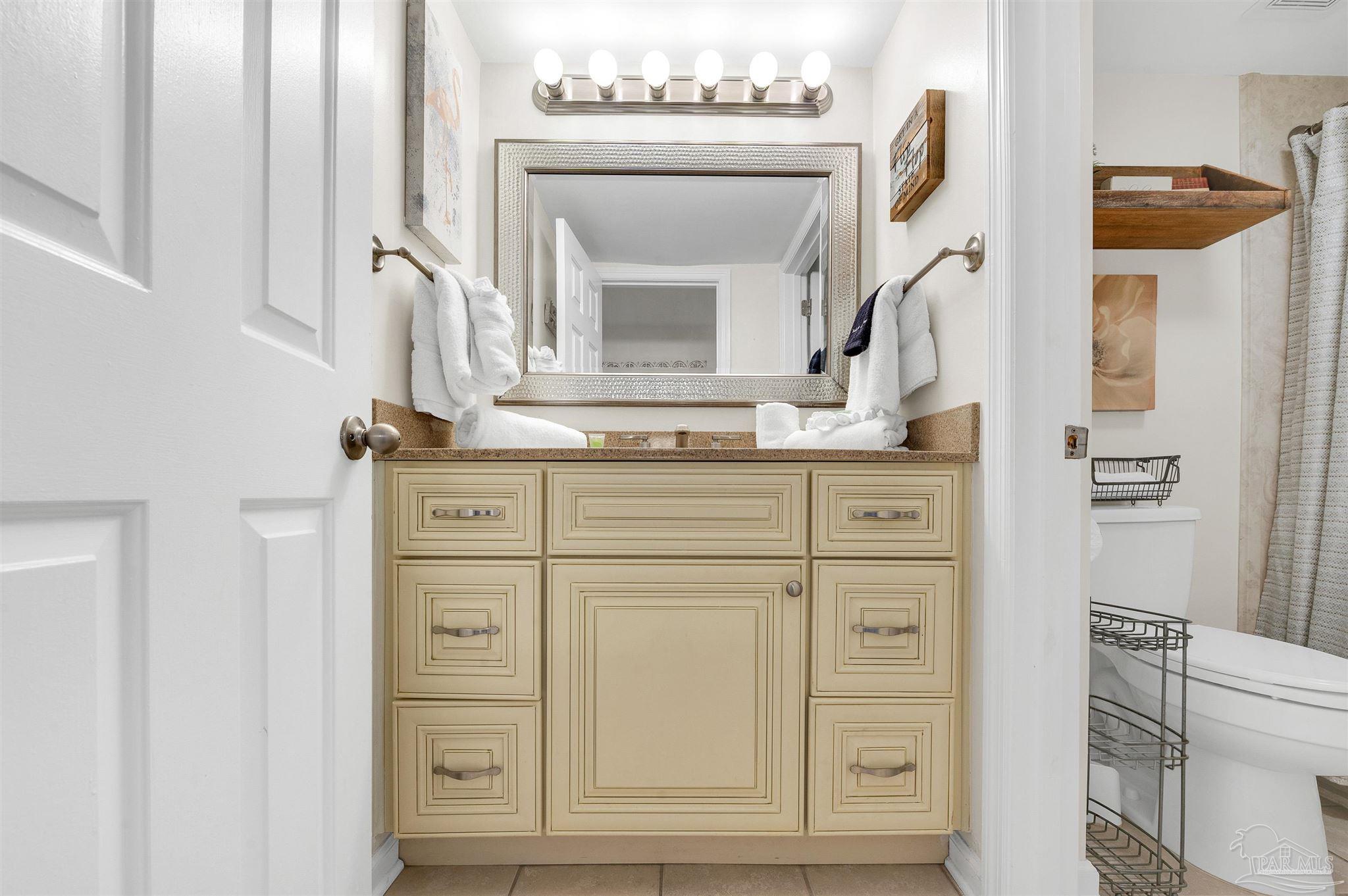13817 Perdido Key Drive, Unit 501 Pensacola, FL 32507 - Photo 46 of 63 a bathroom with a sink vanity and a mirror