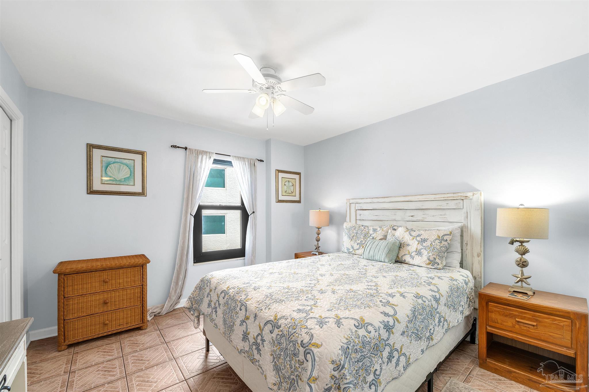 13817 Perdido Key Drive, Unit 501 Pensacola, FL 32507 - Photo 49 of 63 a bedroom with a bed and a chandelier