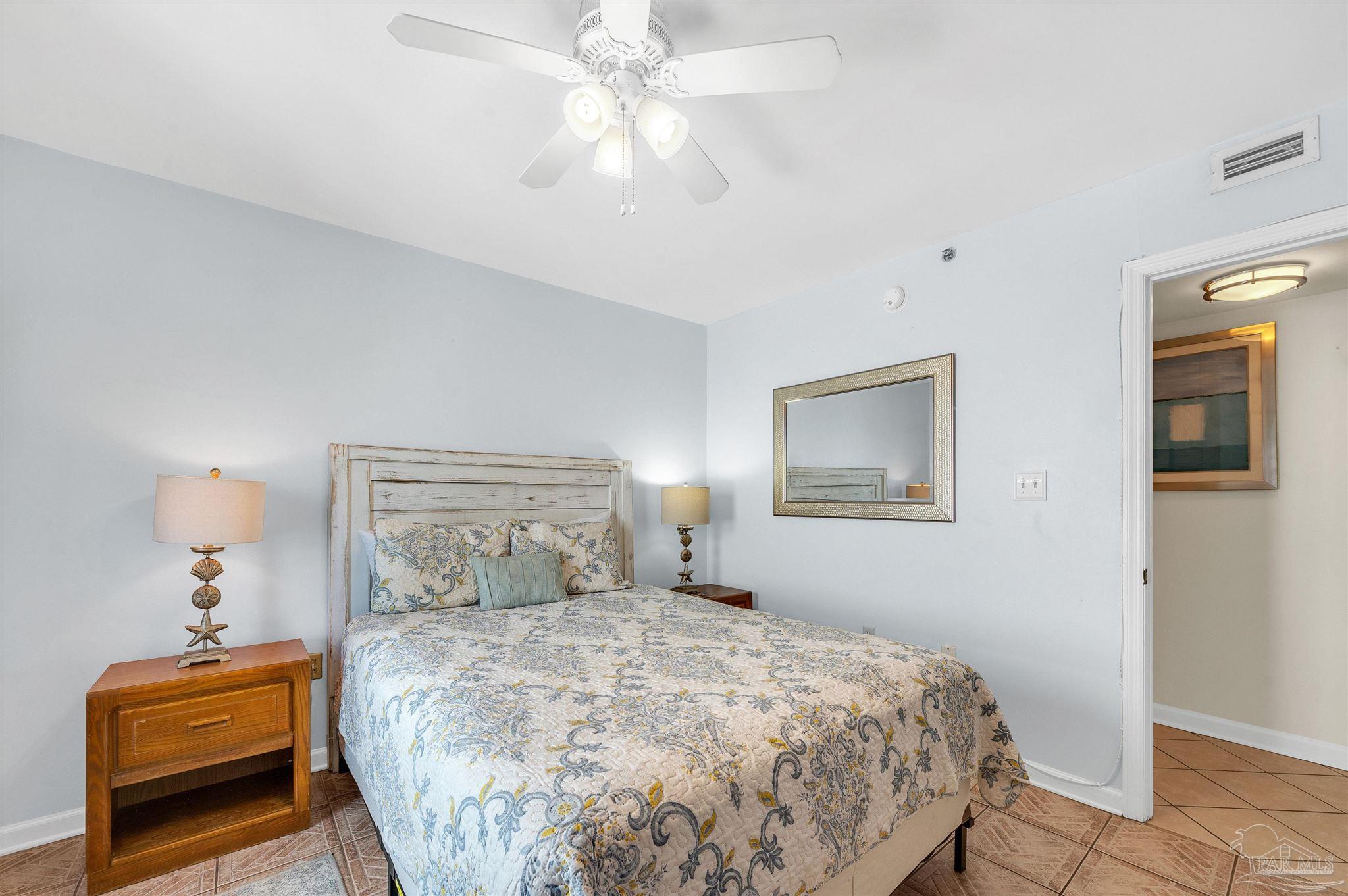 13817 Perdido Key Drive, Unit 501 Pensacola, FL 32507 - Photo 50 of 63 a bedroom with a bed and a chandelier