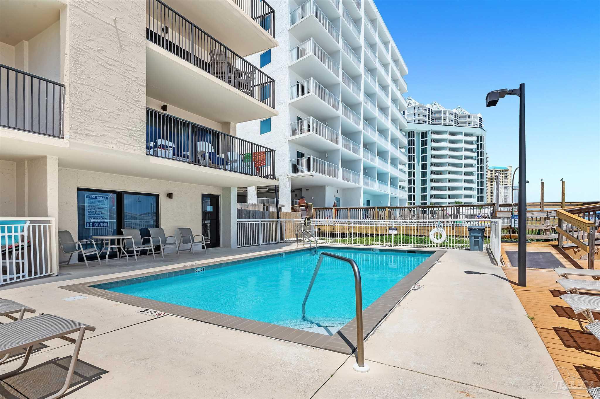 13817 Perdido Key Drive, Unit 501 Pensacola, FL 32507 - Photo 5 of 63 a swimming pool with outdoor seating and yard