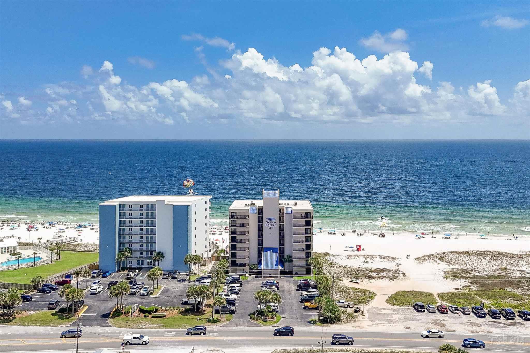 13817 Perdido Key Drive, Unit 501 Pensacola, FL 32507 - Photo 53 of 63 a view of building with an outdoor space and seating