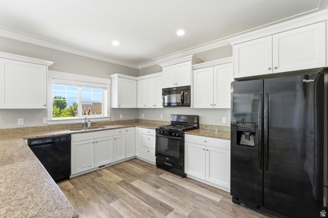 1614 Aspen Loop Provo, UT 84606 - Photo 14 of 47 Modern kitchen featuring white shaker cabinetry, granite-finish countertops, black appliance suite, wood-finish flooring, and a large window above the sink