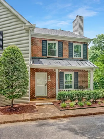 an aerial view of a house with a yard and lake view