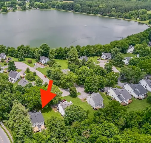 an aerial view of lake residential house with swimming pool and green space