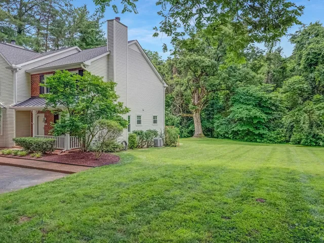 a view of a field of grass and trees