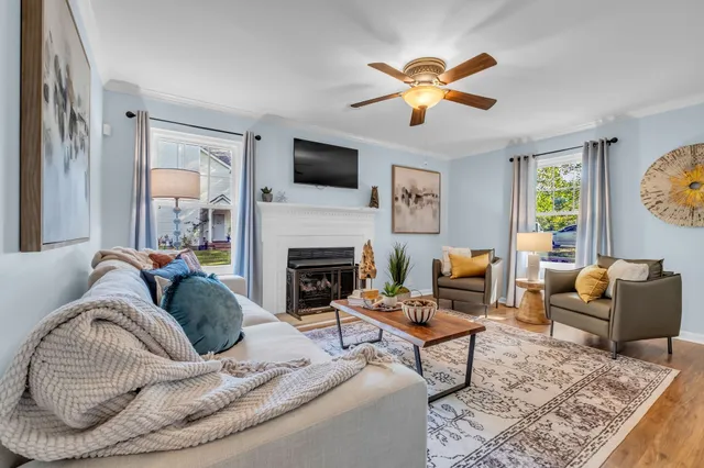 a living room with furniture and a fireplace