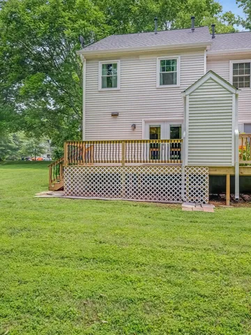 an aerial view of a house with a yard and lake view