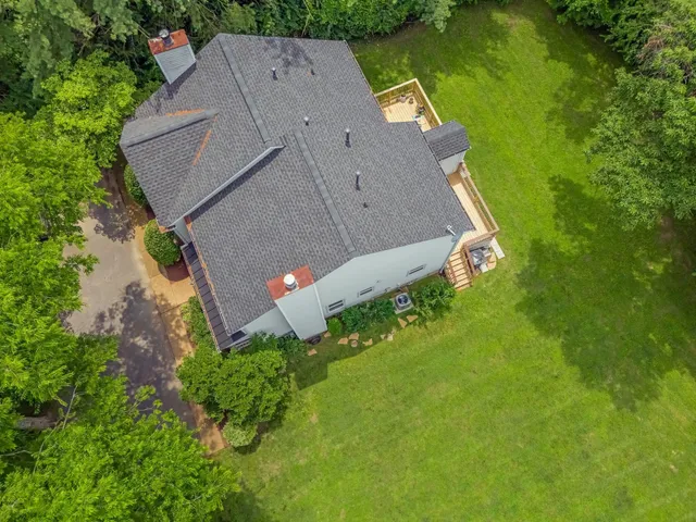 a view of backyard with outdoor seating and green space