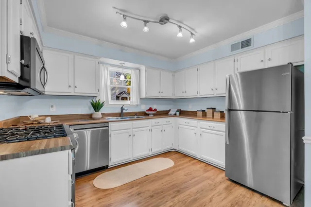 a kitchen with white cabinets and white appliances
