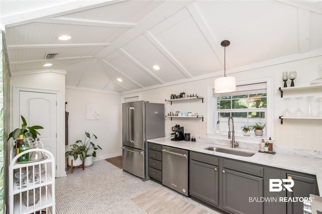5200 Border Drive South Mobile, AL 36608 - Photo 7 of 26 Kitchen with gray cabinetry, sink, stainless steel appliances, vaulted ceiling with beams, and pendant lighting