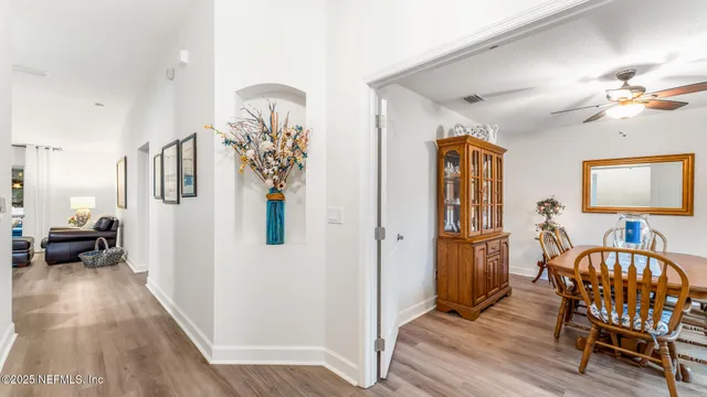 a view of a livingroom with furniture and a ceiling fan