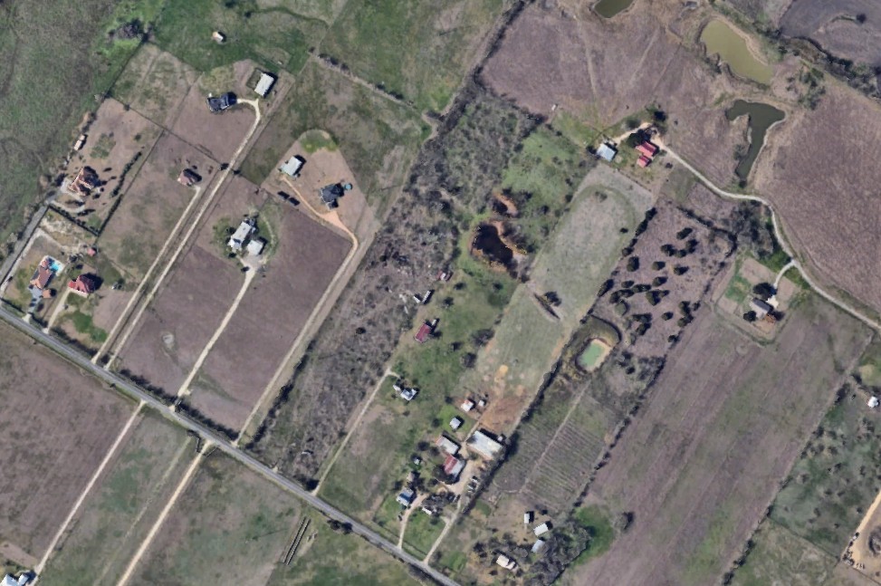 12400 Ballerstedt Road Elgin, TX 78621 - Photo 6 of 7 an aerial view of a house with a yard