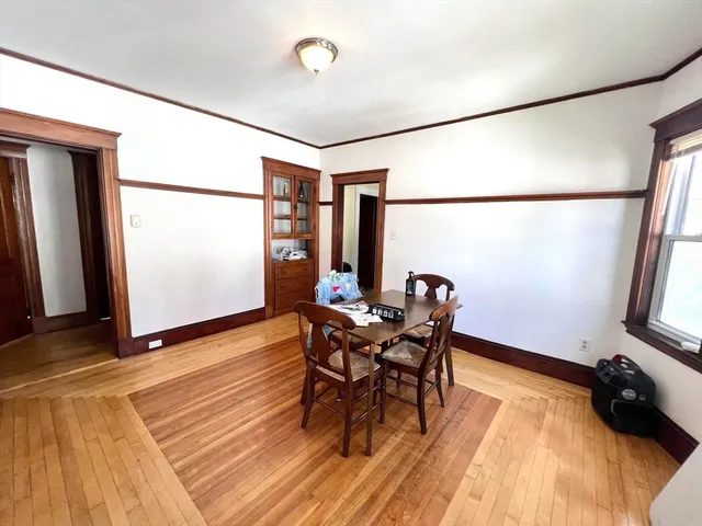a dining room with furniture and wooden floor