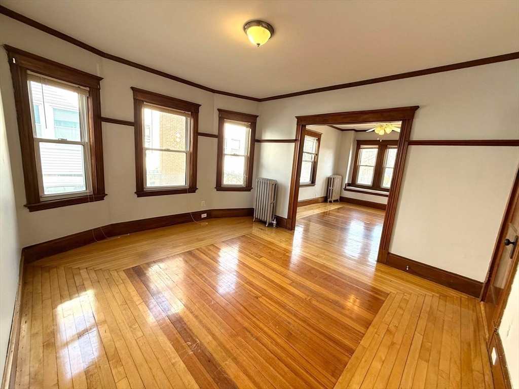 41 Woodward Avenue, Unit 2 Quincy, MA 02169 - Photo 19 of 27 a view of empty room with wooden floor and fan