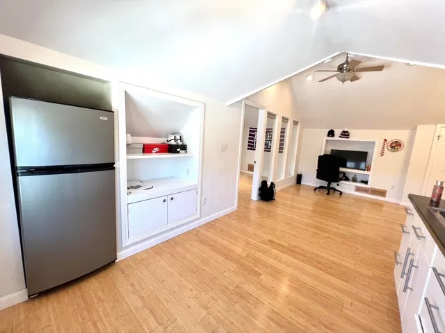 a view of a kitchen with refrigerator and a stove
