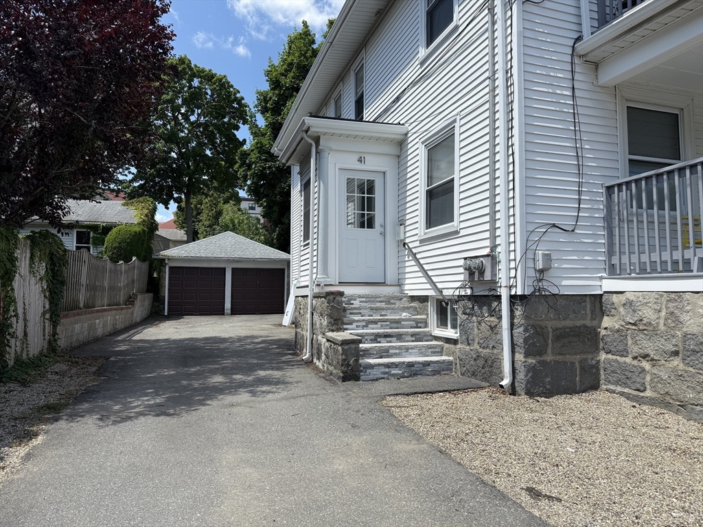 41 Woodward Avenue, Unit 2 Quincy, MA 02169 - Photo 25 of 27 a front view of a house with a garage