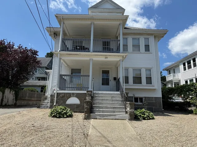 a front view of a house with a yard and a garage