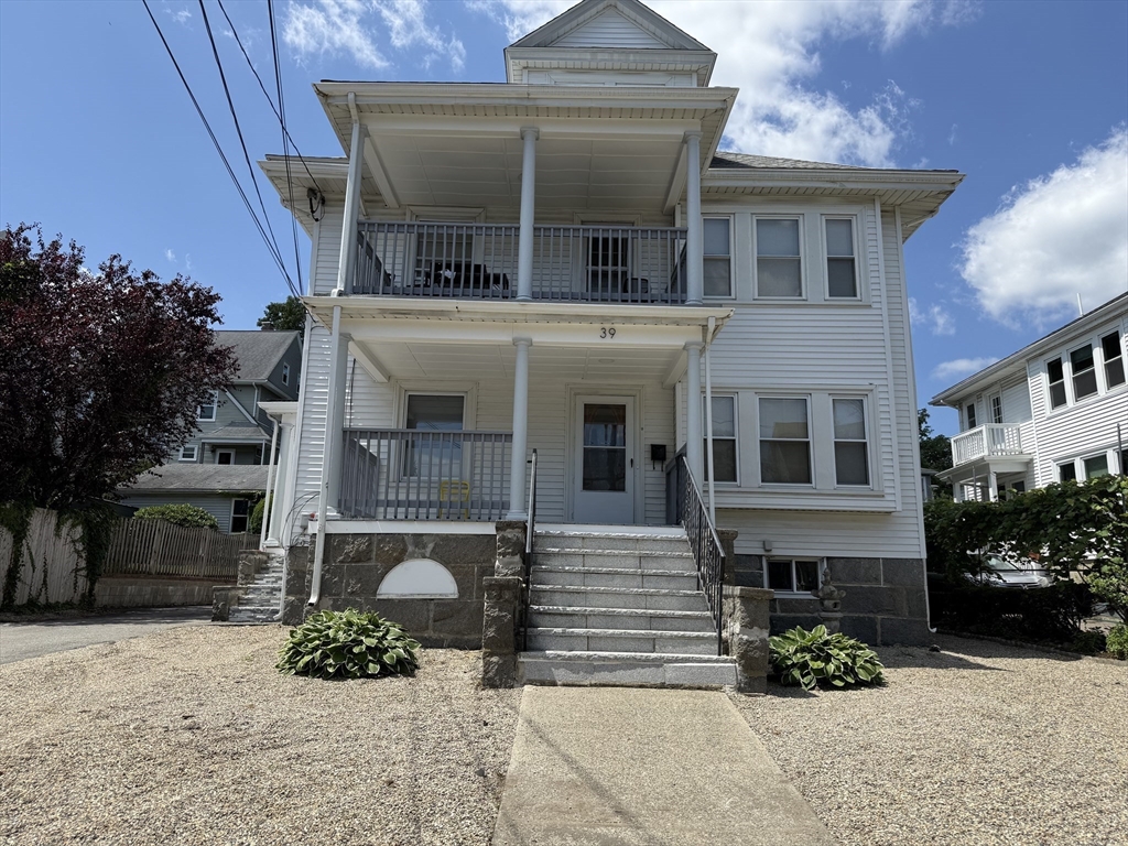 41 Woodward Avenue, Unit 2 Quincy, MA 02169 - Photo 26 of 27 a front view of a house with a yard and a garage