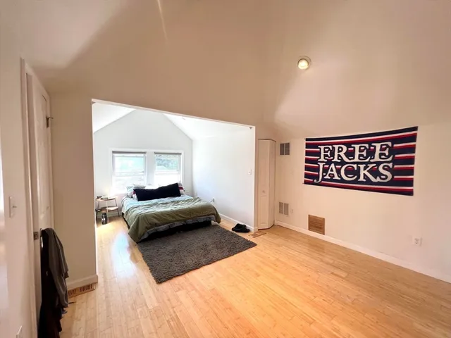 a bedroom with a bed and a large mirror