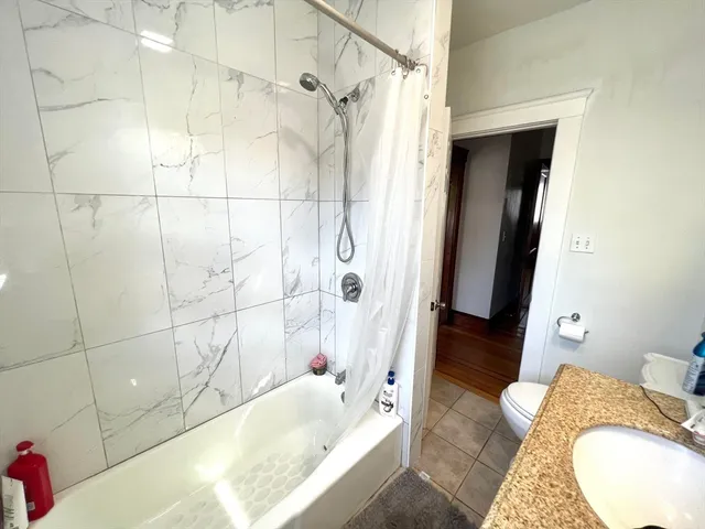 a bathroom with a tub and shower