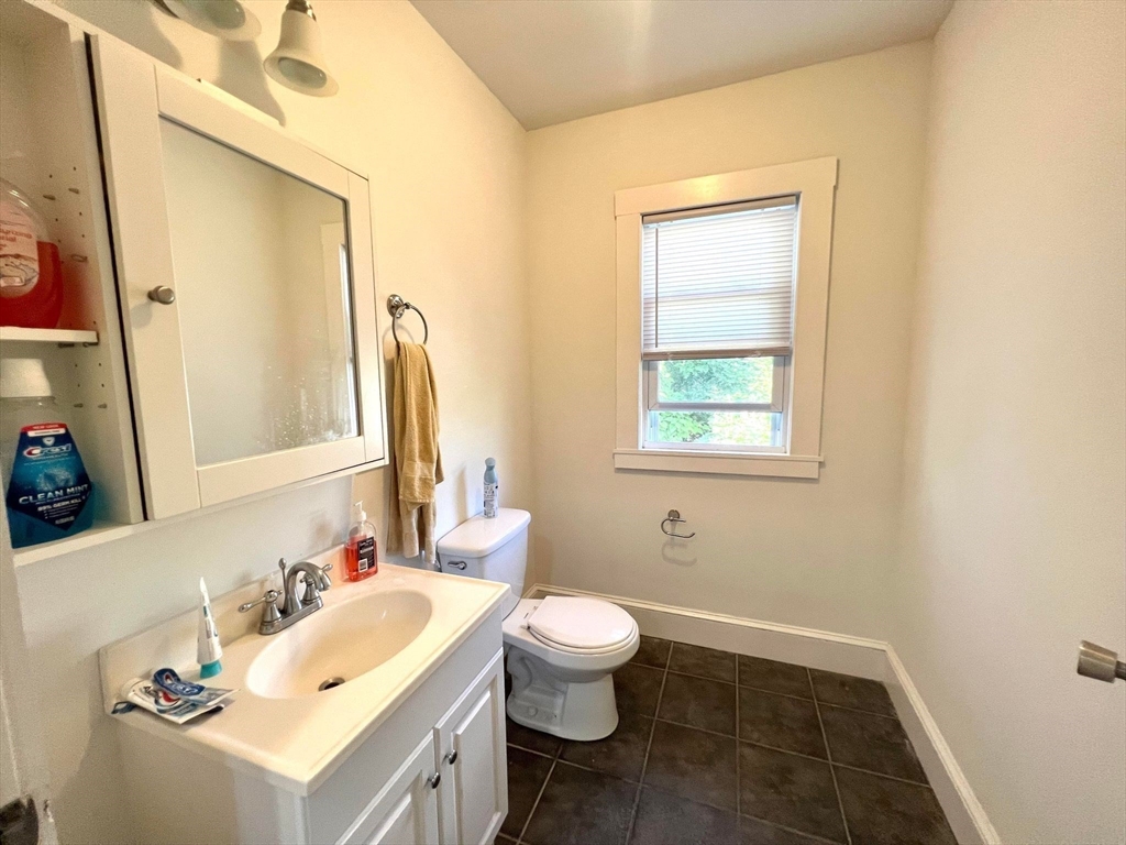 41 Woodward Avenue, Unit 2 Quincy, MA 02169 - Photo 10 of 27 a bathroom with a sink vanity mirror and toilet