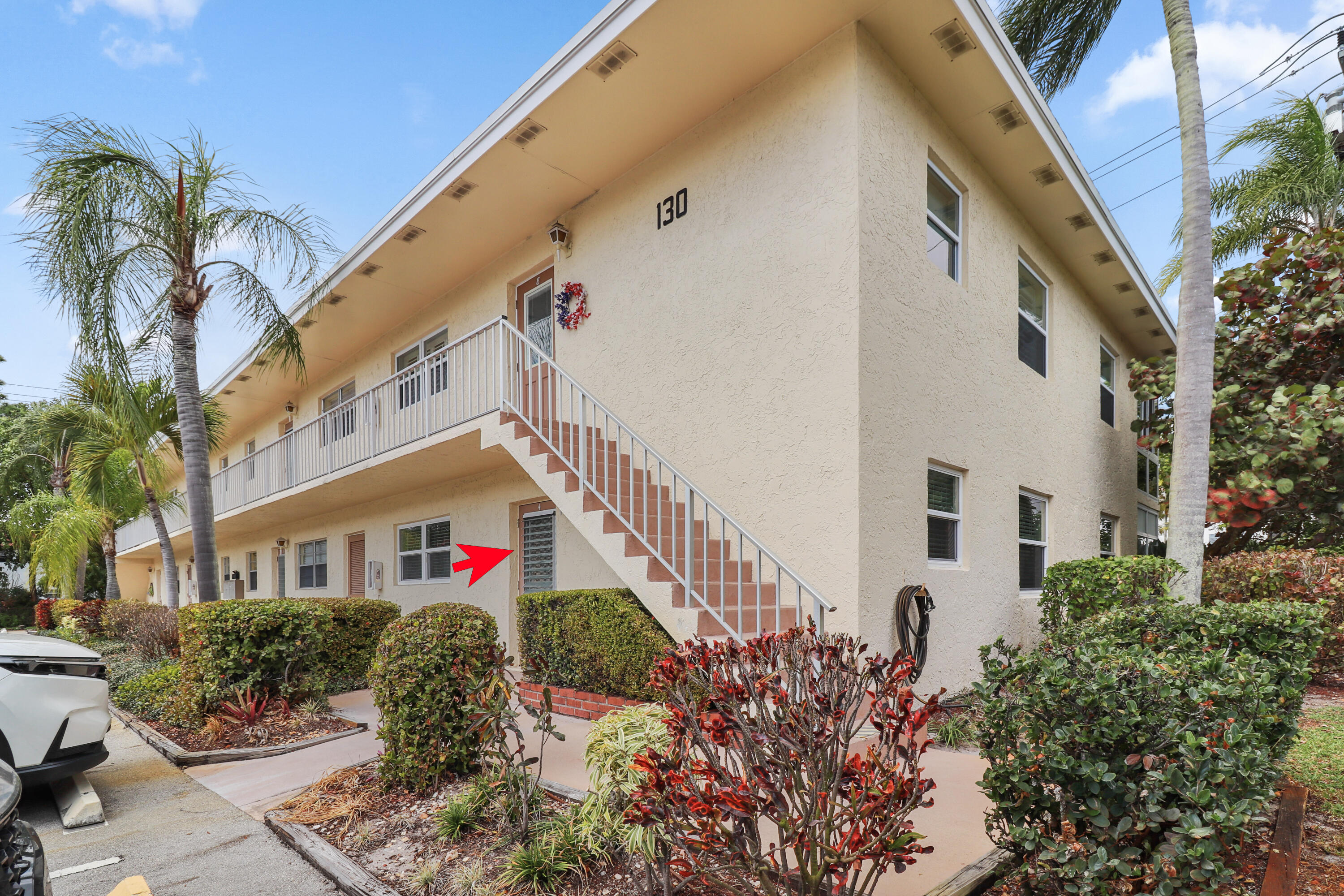 2950 Southeast Ocean Boulevard, Unit 1304 Stuart, FL 34996 - Photo 1 of 35 a front view of multi story residential apartment building with yard and sign board