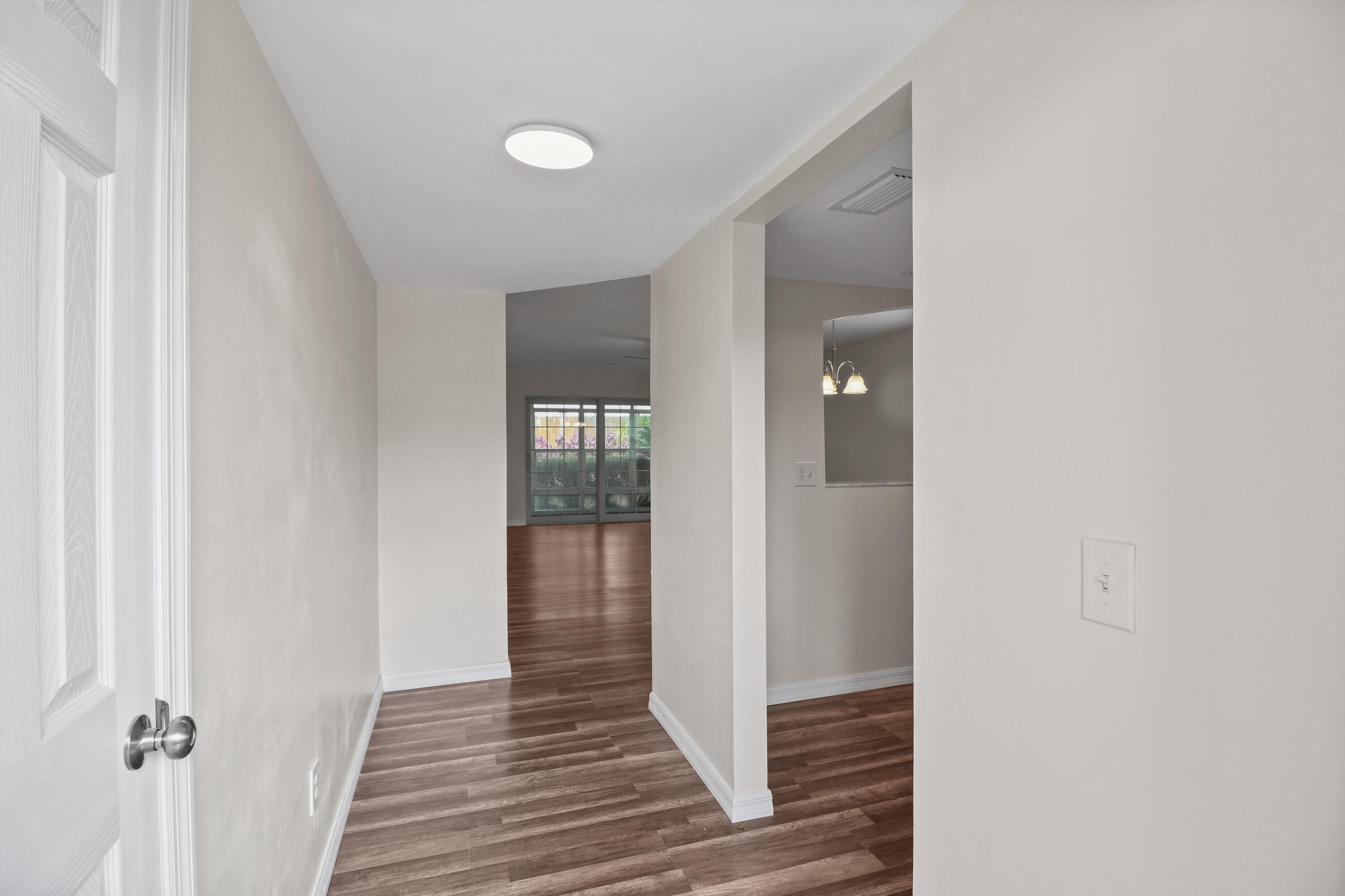 2950 Southeast Ocean Boulevard, Unit 1304 Stuart, FL 34996 - Photo 11 of 35 a view of a hallway with wooden floor and staircase