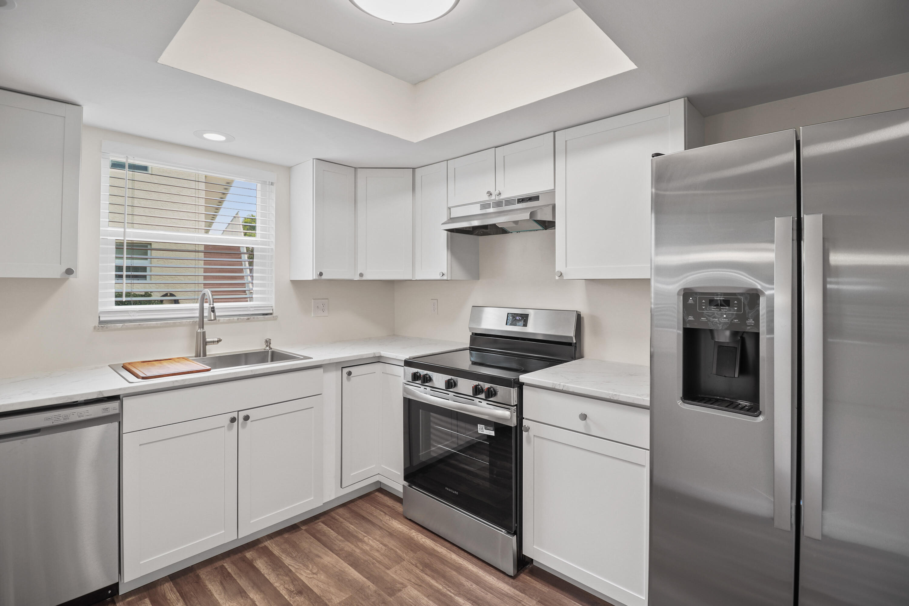 2950 Southeast Ocean Boulevard, Unit 1304 Stuart, FL 34996 - Photo 13 of 35 a kitchen with cabinets appliances and a window