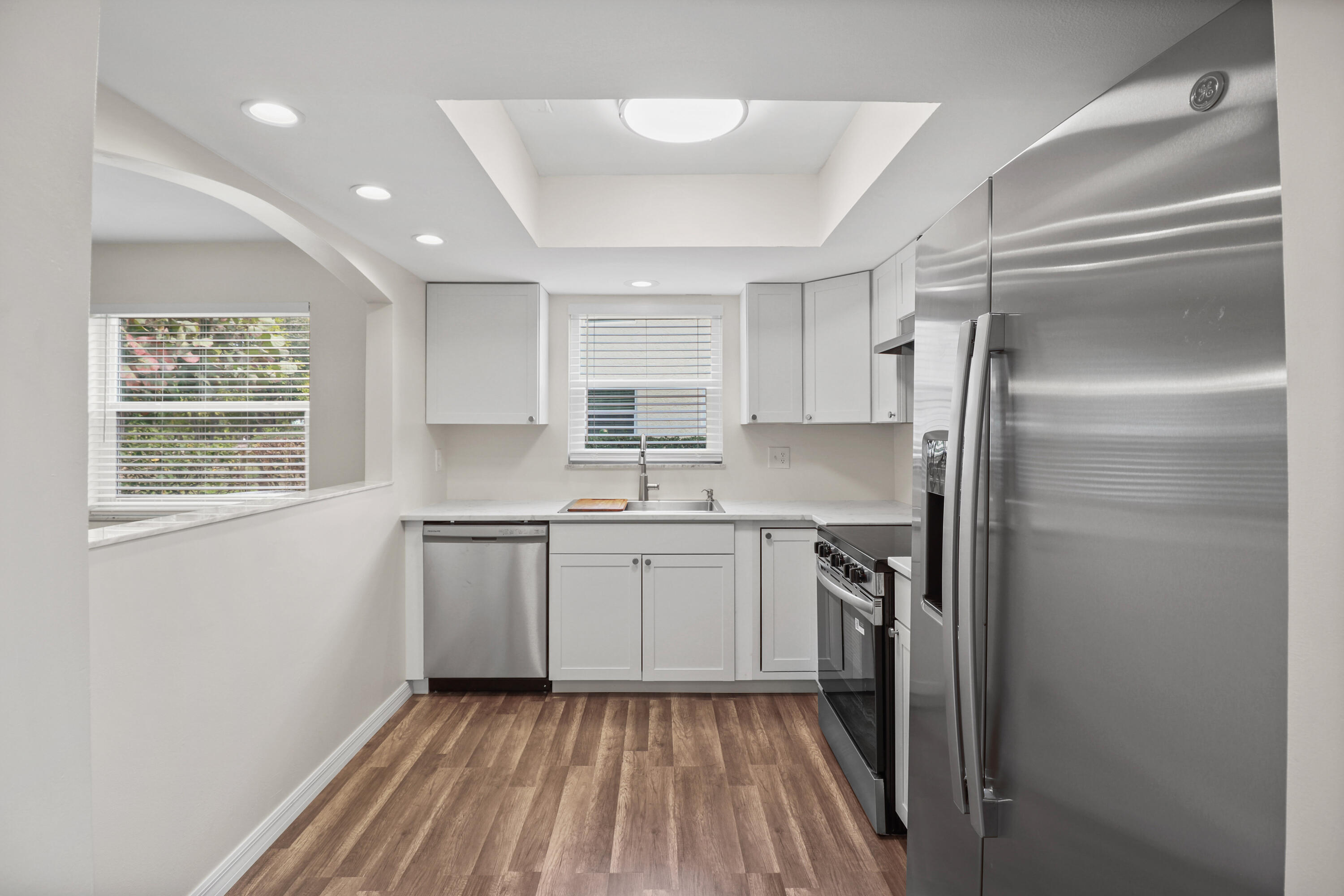 2950 Southeast Ocean Boulevard, Unit 1304 Stuart, FL 34996 - Photo 14 of 35 a kitchen with a sink stainless steel appliances and cabinets