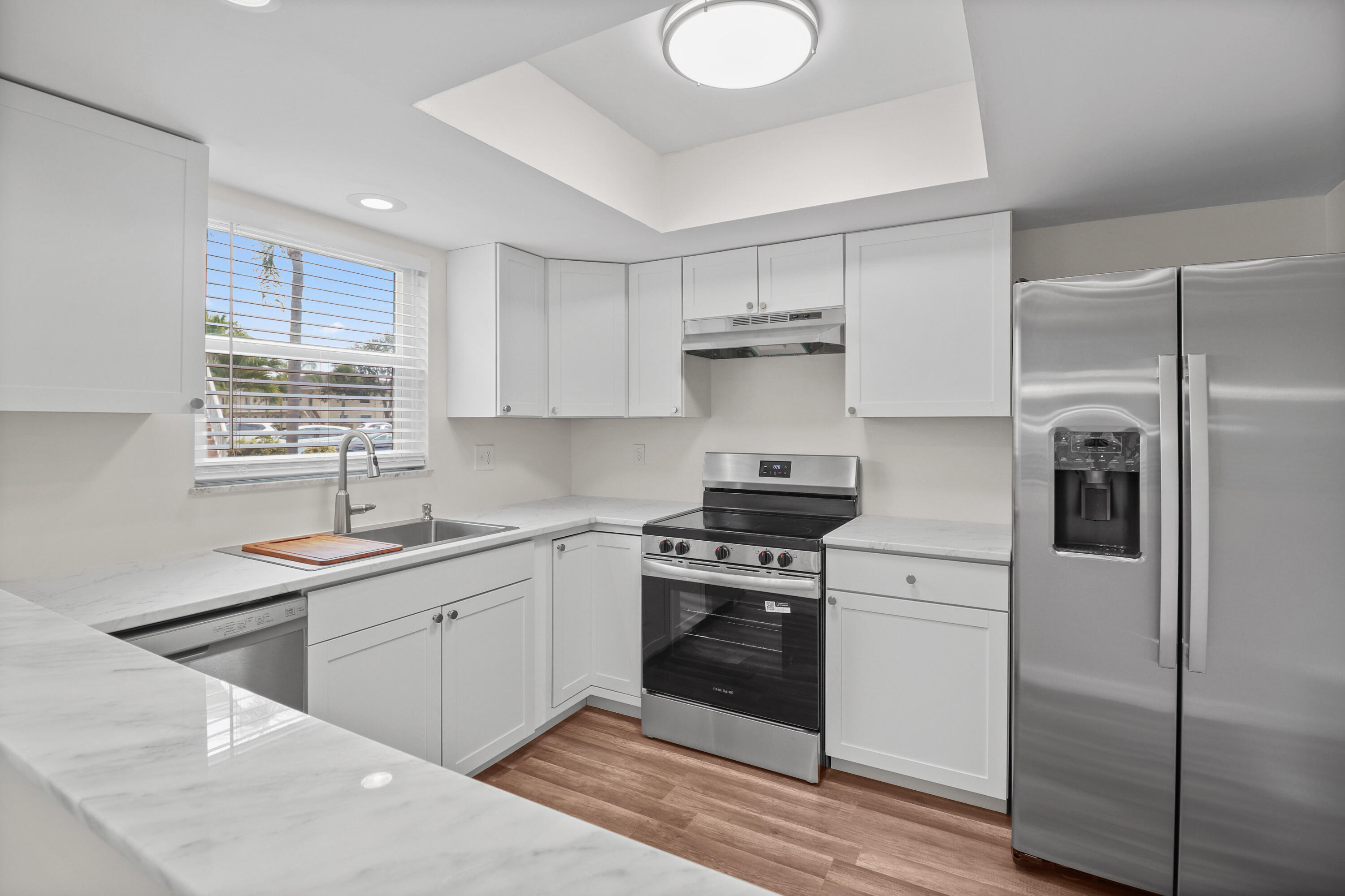 2950 Southeast Ocean Boulevard, Unit 1304 Stuart, FL 34996 - Photo 15 of 35 a kitchen with a sink appliances and cabinets