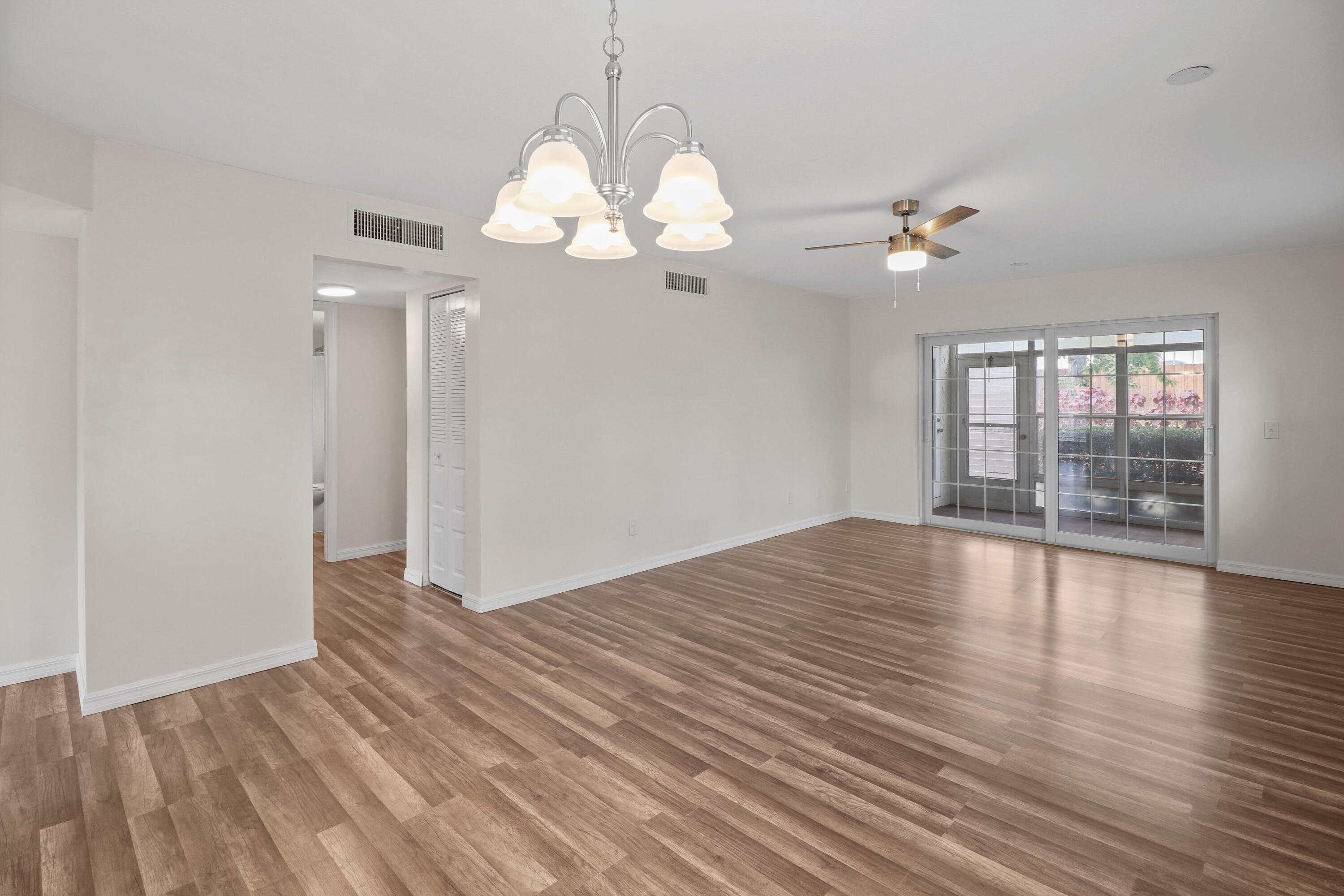 2950 Southeast Ocean Boulevard, Unit 1304 Stuart, FL 34996 - Photo 18 of 35 a view of an empty room with wooden floor and a window