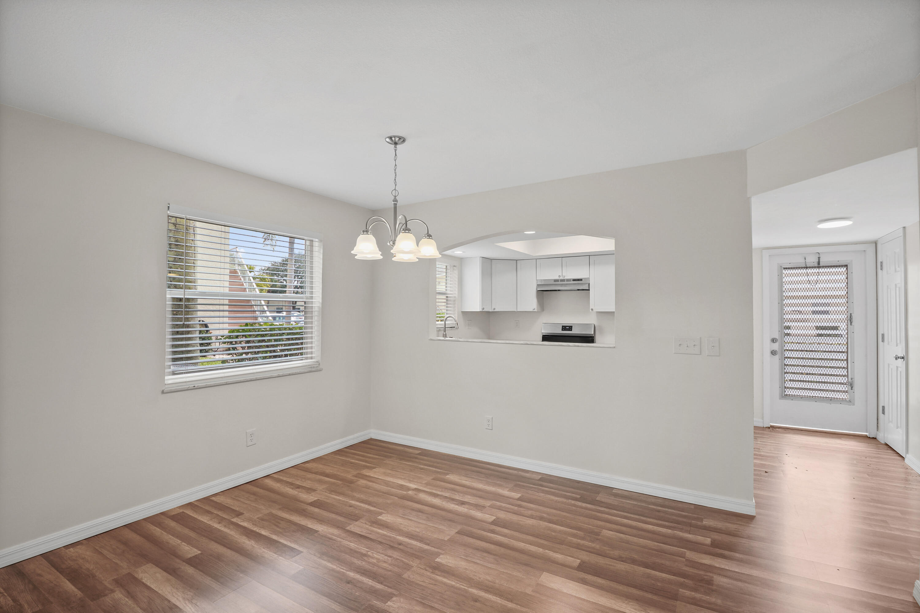 2950 Southeast Ocean Boulevard, Unit 1304 Stuart, FL 34996 - Photo 20 of 35 a view of an empty room with wooden floor and a window