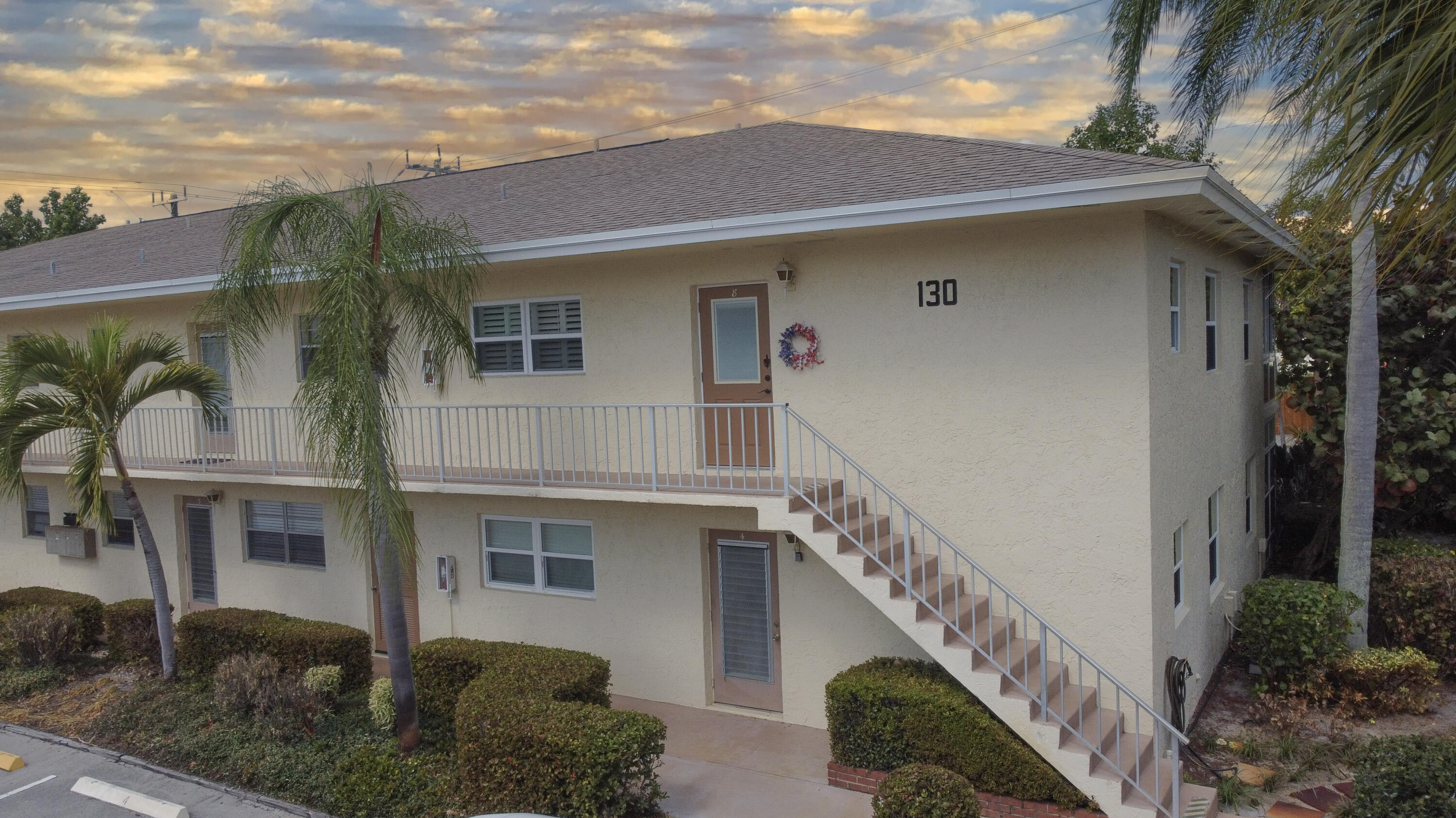 2950 Southeast Ocean Boulevard, Unit 1304 Stuart, FL 34996 - Photo 2 of 35 a front view of a house with a yard