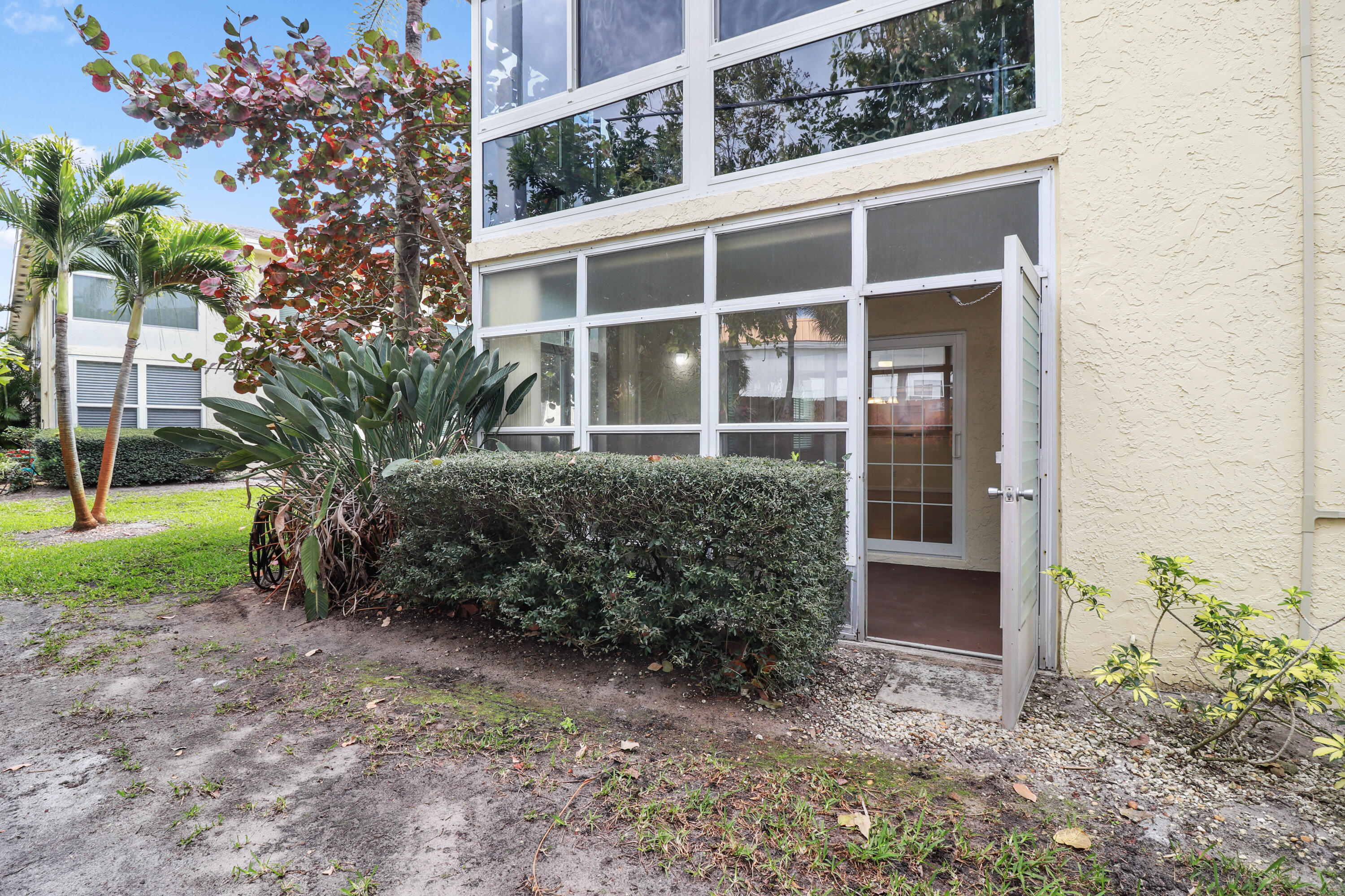 2950 Southeast Ocean Boulevard, Unit 1304 Stuart, FL 34996 - Photo 30 of 35 a view of a house with a yard and potted plants
