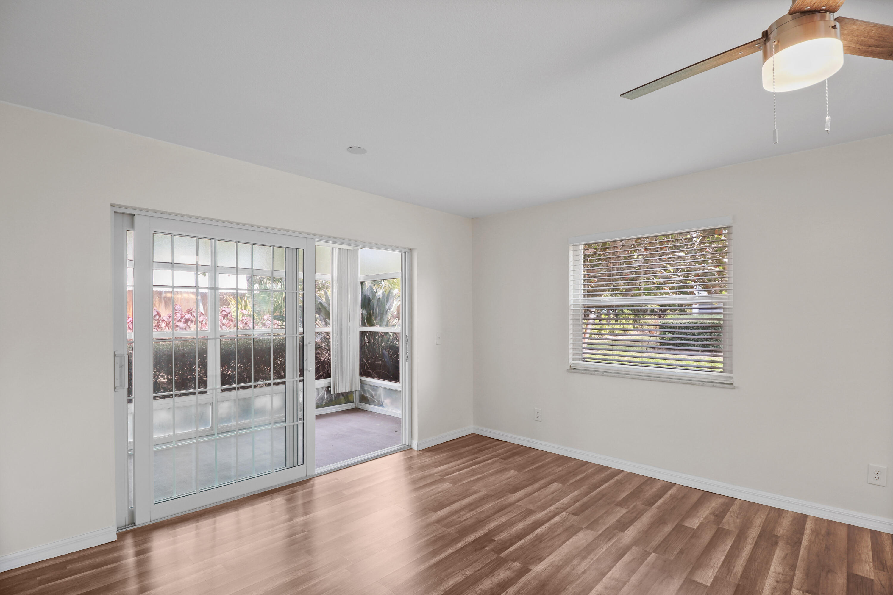 2950 Southeast Ocean Boulevard, Unit 1304 Stuart, FL 34996 - Photo 32 of 35 a view of an empty room with wooden floor and a window