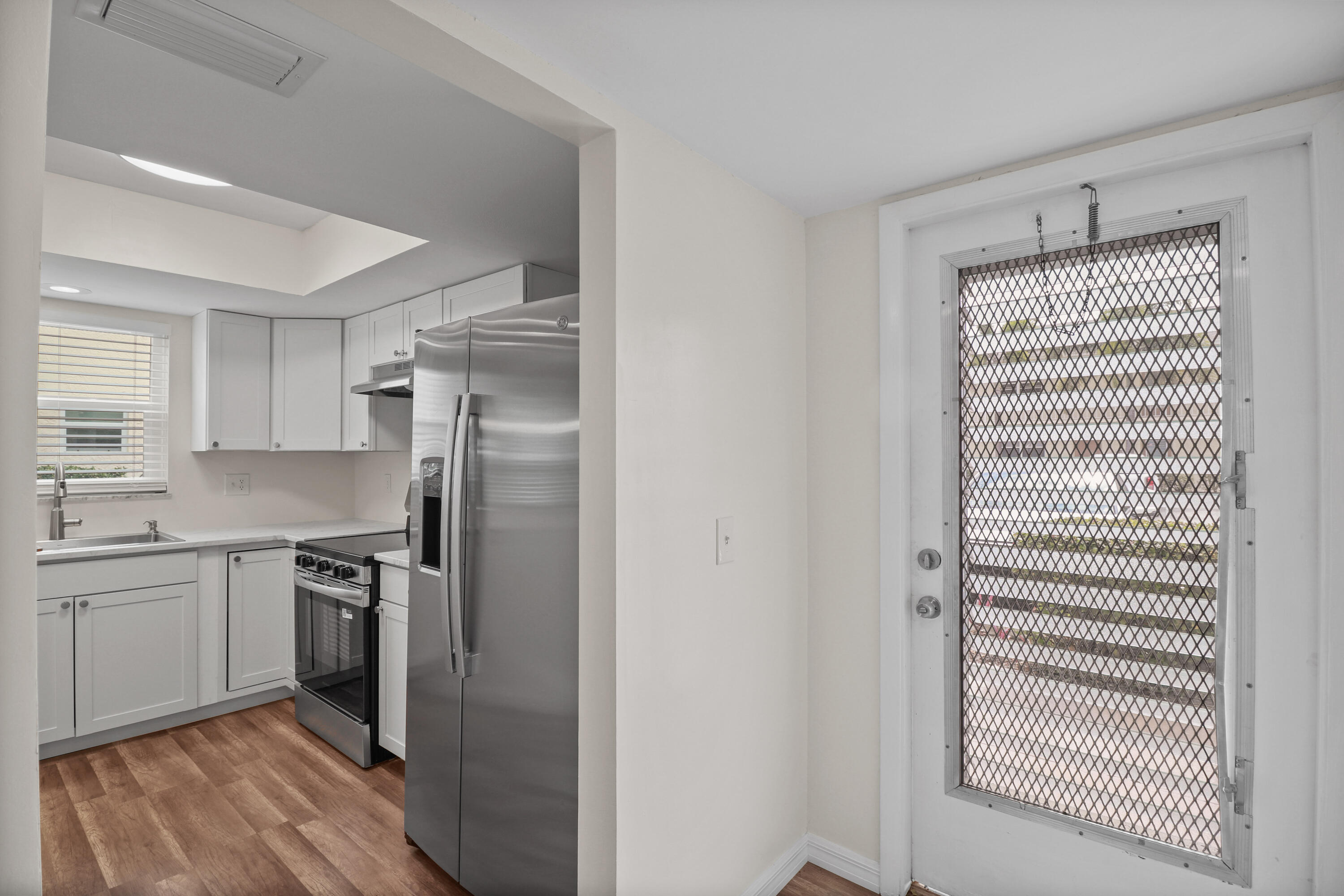 2950 Southeast Ocean Boulevard, Unit 1304 Stuart, FL 34996 - Photo 34 of 35 a kitchen with a sink stainless steel appliances and cabinets