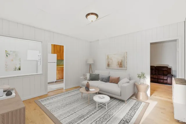 a view of a hallway with a couch and a refrigerator