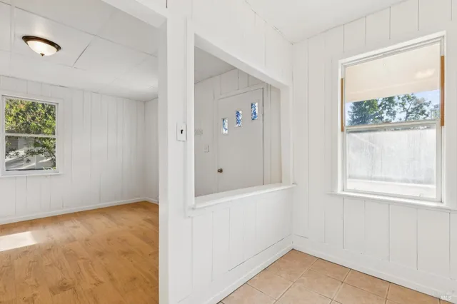 a kitchen with a sink a refrigerator and cabinets