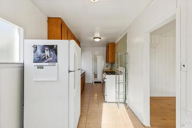 a bedroom with a bed and painting on the wall